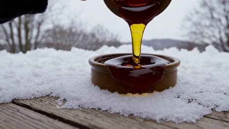 maple syrup pouring on snow