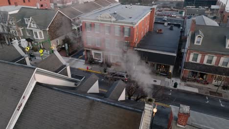 rooftop view of chimney with smoke in cold winter scene