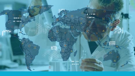 animation of world map over caucasian male scientist working in lab