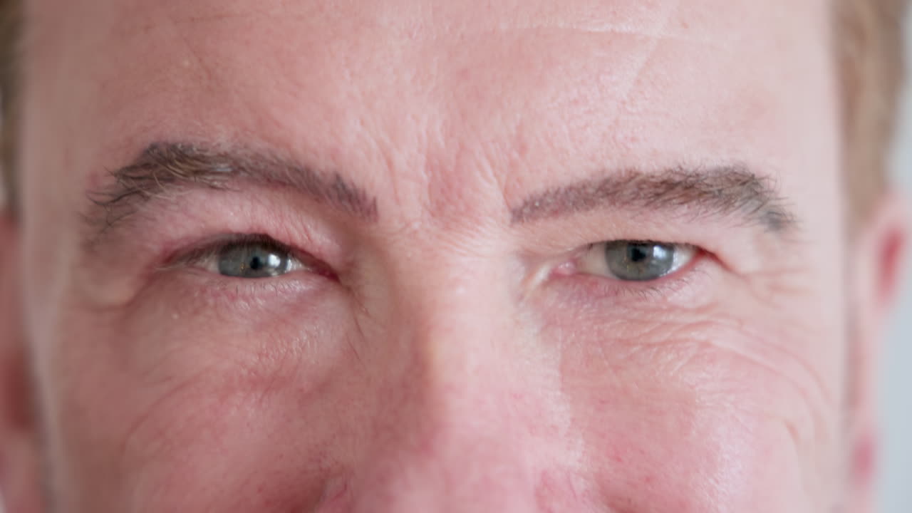 Close-up of senior man's joyful eyes, expressing warmth and happiness, at home