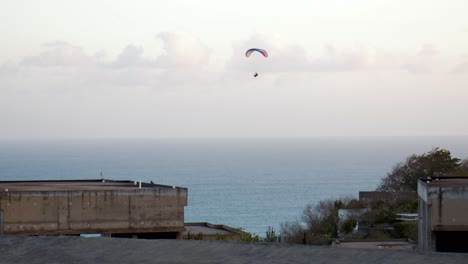 Handheld-shot-of-a-paraglider-enjoying-a-scenic-flight-over-the-dramatic-cliffs-of-Bali