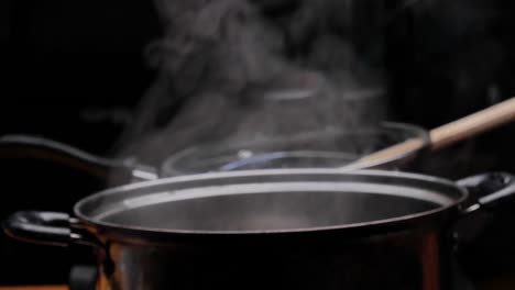 cassava is being boiled in a pot of boiling water to making thai dessert, cassava root with coconut milk or singkong rebus, traditional indonesian food.