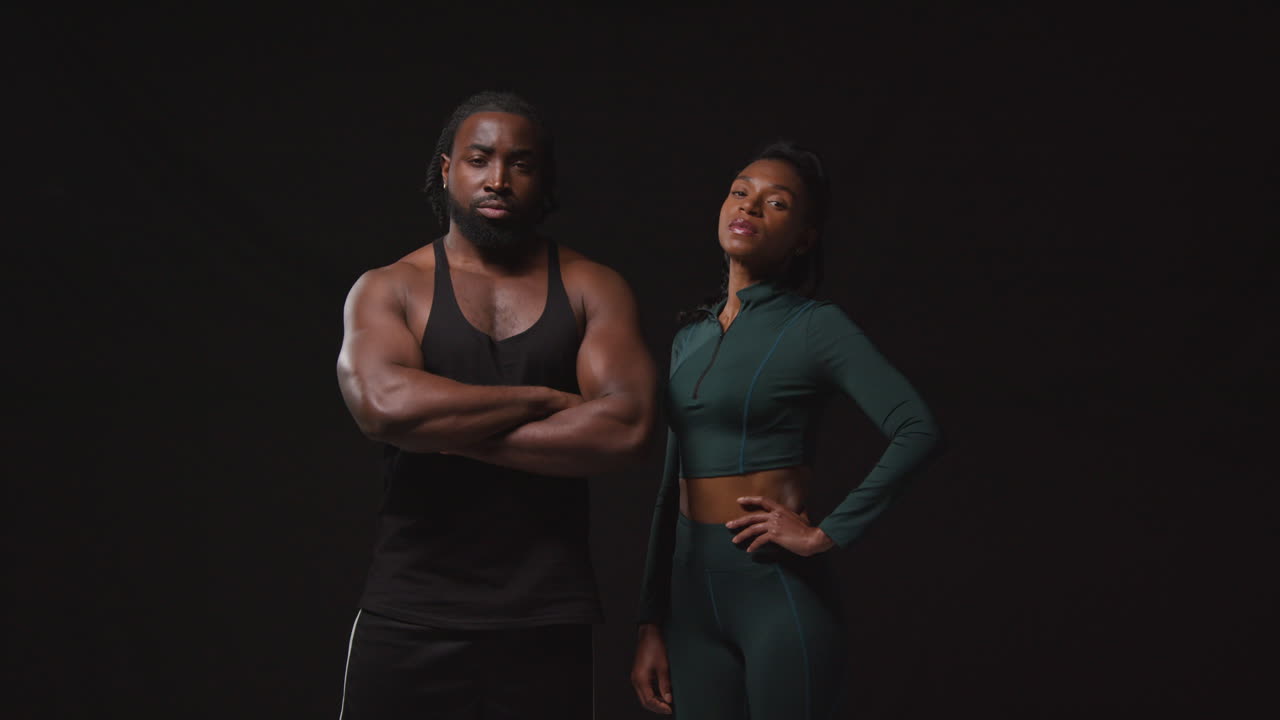 Studio Portrait Of Determined Male And Female Athletes Training In Fitness Clothing Shot Against Black Background 2