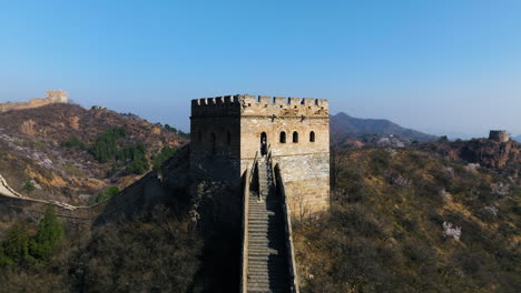 tourist enjoying view from jinshanling tower of great wall of china in hebei province, china. drone pullback shot