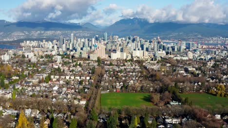 baseball field with residential houses and downtown vancouver in background in canada