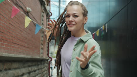 Young Woman Dancing in City Alley