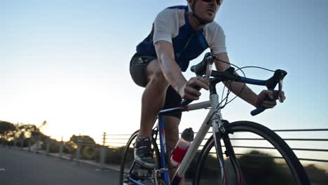healthy man cycling road bicycle outdoors fitness steadicam shot