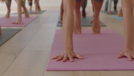 close up group of women in yoga class practicing downward-facing dog pose training healthy lifestyle exercising enjoying fitness studio meditation