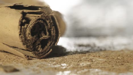 Macro-shot-of-Cinnamom-stick-falls-on-table-surface-covered-in-Cinnamom-powder,-Super-Slow-motion