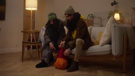 couple packing a backpack at home
