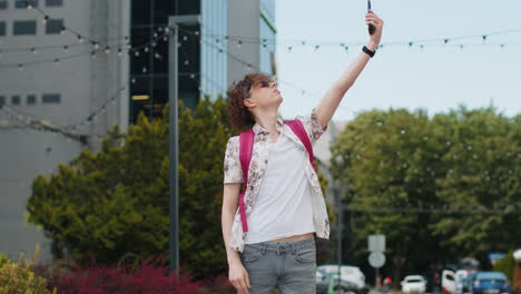 tourist with backpack trying to catch a communication signal and internet connection on mobile phone