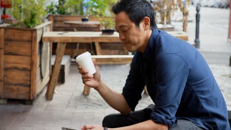 man having coffee while using mobile phone 4k