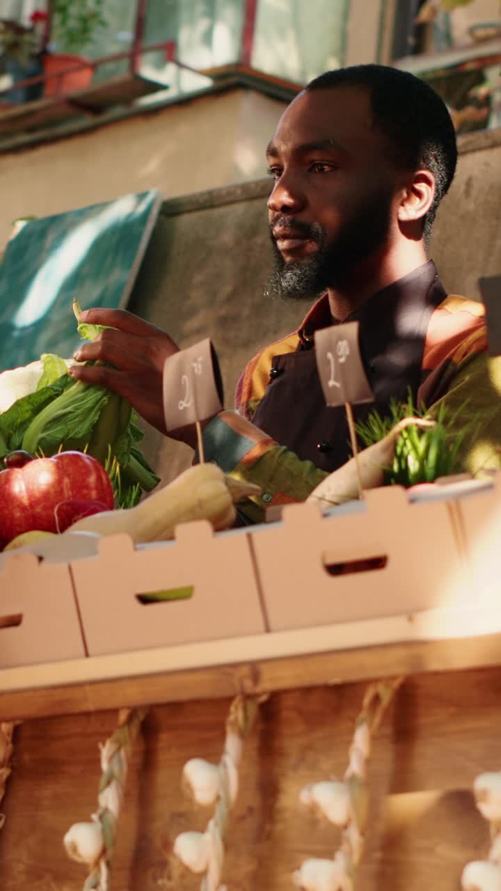 Vertical video: Young male seller showing natural eco produce to woman
