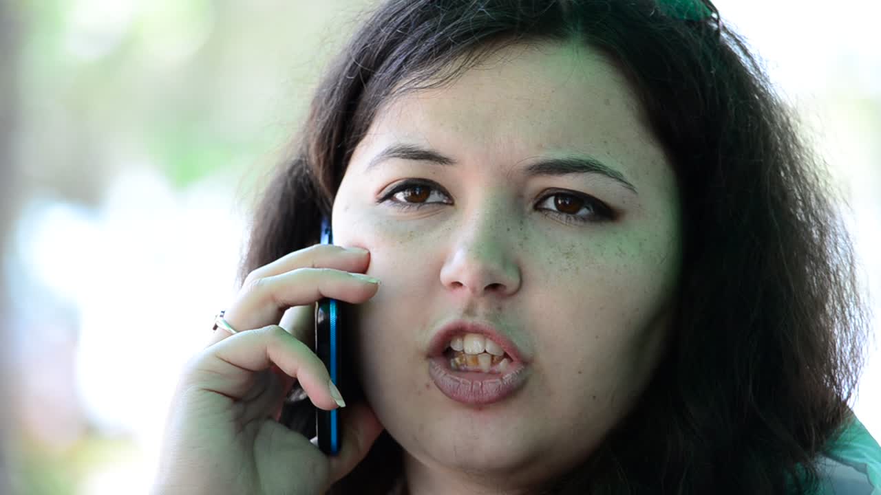 Shooting in cafe. Conversation of the young girl by phone