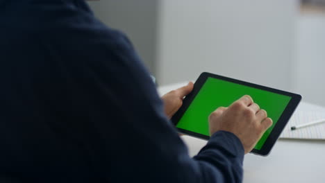 close-up view of businessman hands touching tablet screen with chroma key