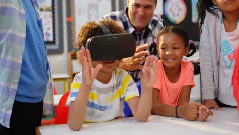 Front-view-of-African-american-schoolboy-using-virtual-reality-headset-in-the-classroom-4k