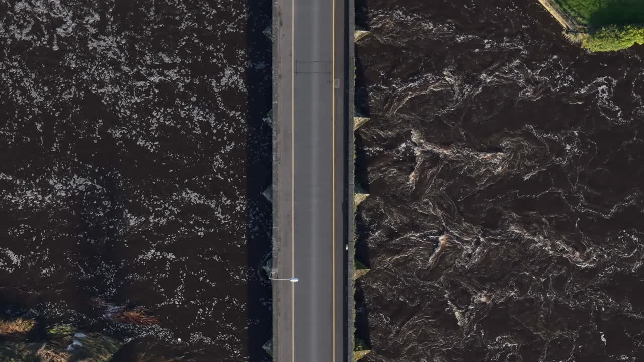 Road Bridge Spanning The Boyne River In Daytime. - aerial overhead shot