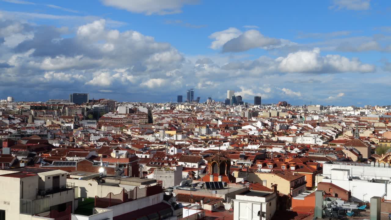 Madrid city on sunny day, modern buildings in background. Aerial, static