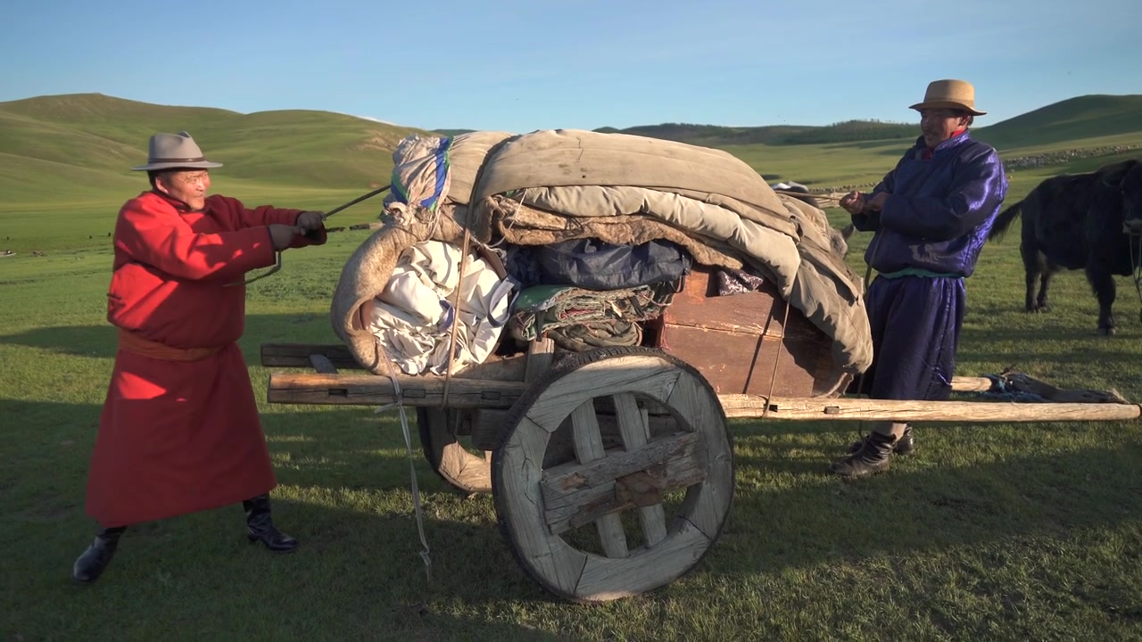 Mongolske nomader trækker en traditionel trækærre over steppen