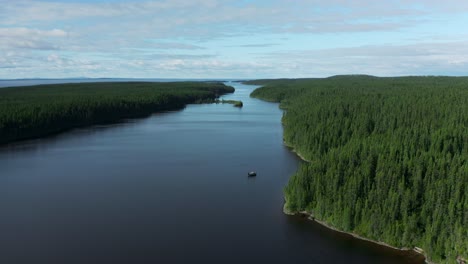 drone flying down on a fishing boat in a wild and beautiful creek on a summer day in northern quebec