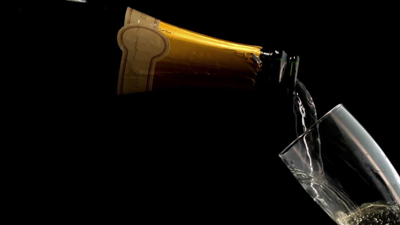 Champagne Pouring into a Glass on a Dark Background