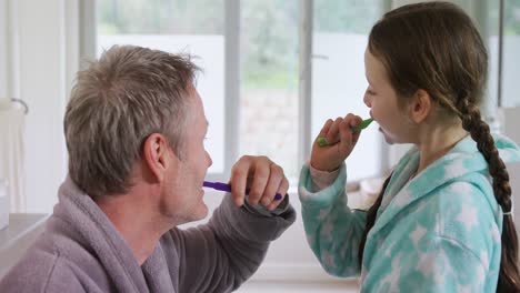 Father-and-daughter-brushing-off-their-teeth-4k
