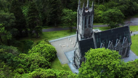 ireland - gothic style architecture on kylemore abbey castle building, aerial drone pullaway