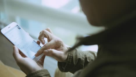 man using smartphone on metro station