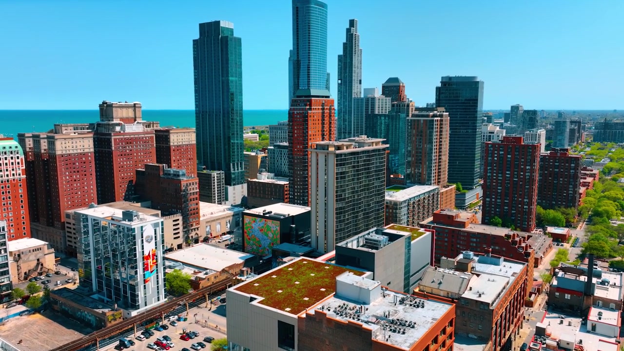 Sunny urban panorama of Chicago downtown. City scenery at the backdrop of lake waterscape and blue sky.