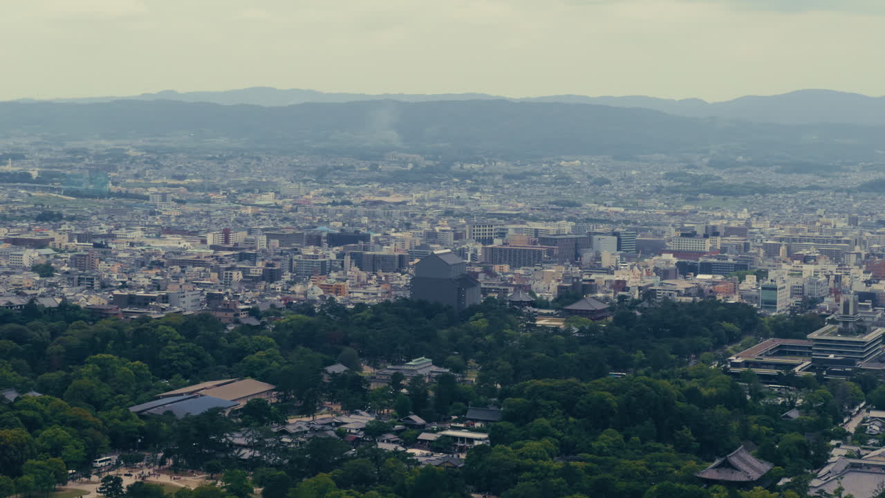 Urban Nara Horizon – Quiet rooftops blend into the modern skyline with mountains in the background