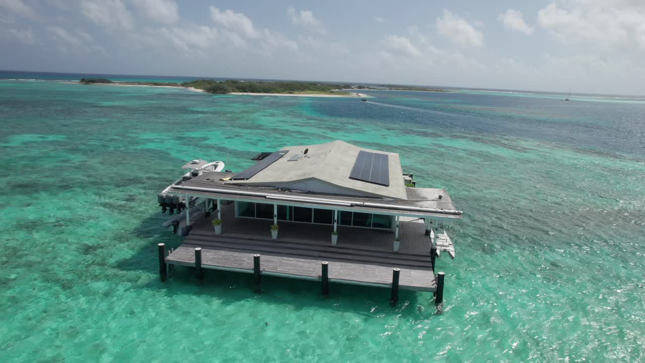 Remote palafito on turquoise waters in Los Roques creates a tranquil scene
