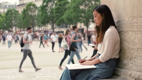 young woman sketching in paris