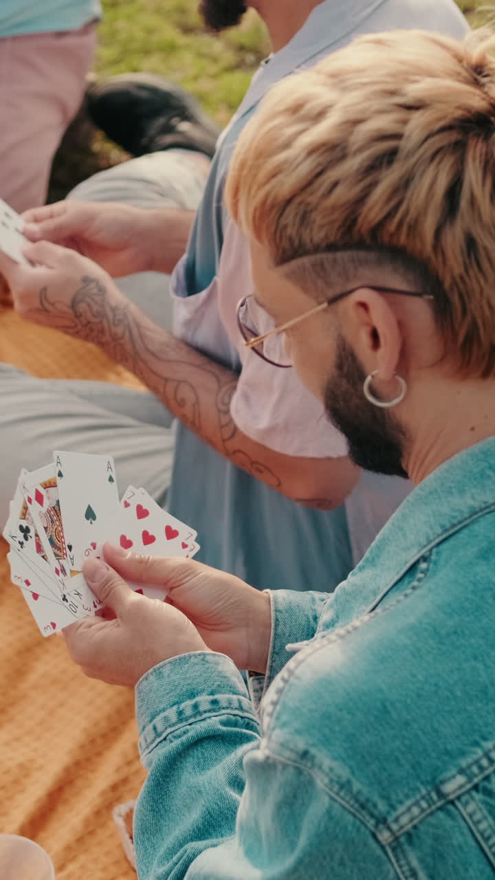 Friends Playing Cards at a Picnic