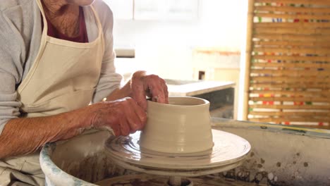 female potter making a pot