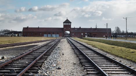 Looking-down-Auschwitz-railway-entrance-towards-museum-building-low-angle