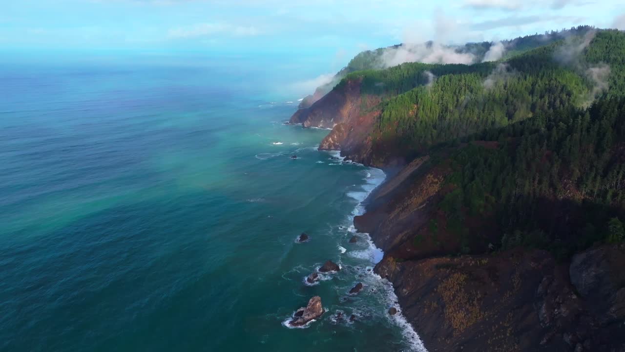 PNW Lost Coast Trail rugged dramatic untouched coastline aerial drone California surf waves boulder rocks USAL Beach campground cloudy mist fog sun rays morning nature landscape backwards motion