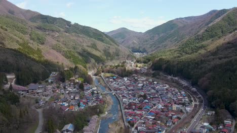 scenic aerial view of  kiso-hirasawa town in kiso valley located in the nagano prefecture, japan. dolly forward, establishing shot