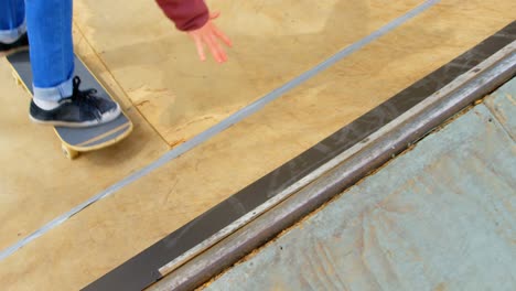 low section of young man doing skateboard trick on skateboard ramp at skateboard court 4k