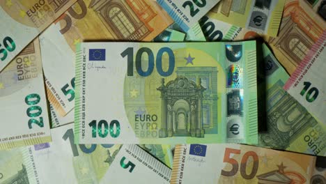 pile of euro banknotes, featuring a 100 euro note