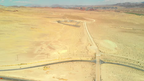 aerial flyover of highway to small desert community