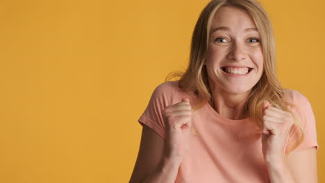 caucasian woman getting excited and showing thumbs up on camera.