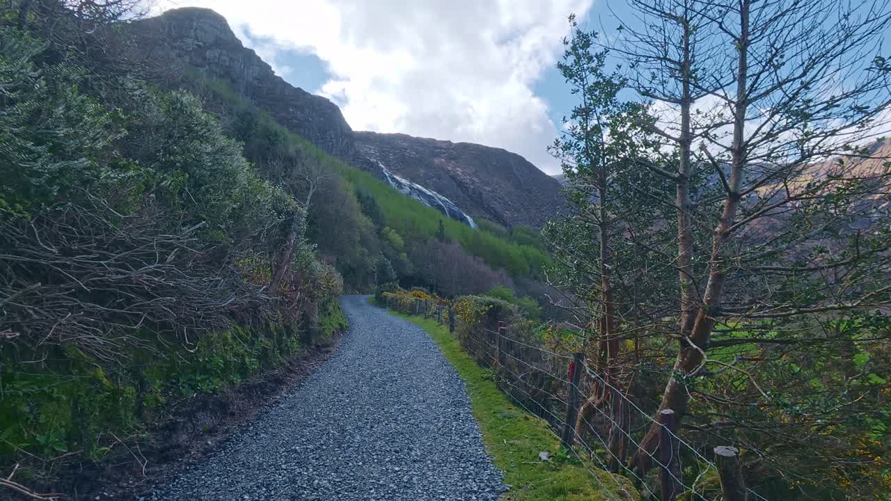 Trail trough Irish countryside to Gleninchquin waterfall Kerry on a spring morning epic location