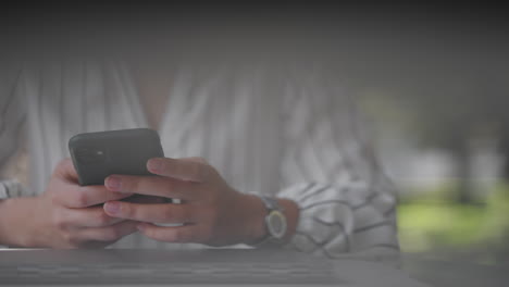 close-up-of-a-woman-typing-on-a-mobile-phone-screen-while-sitting-in-a-summer-cafe.-Internet-banking-surfing-mobile-sites