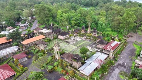 remote hindu temple abandoned in bali, pura jati batur. aerial crane, religious complex.