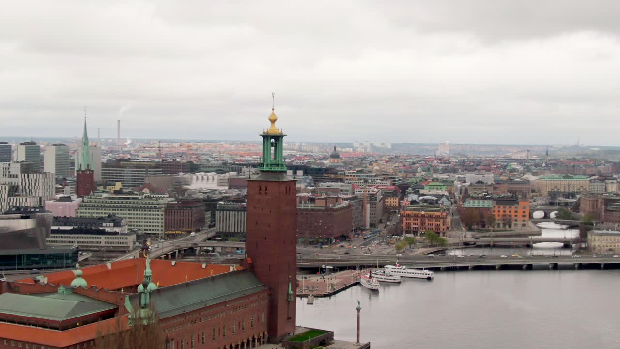 Aerial drone orbit around Stockholm City Hall with the skyline as backdrop