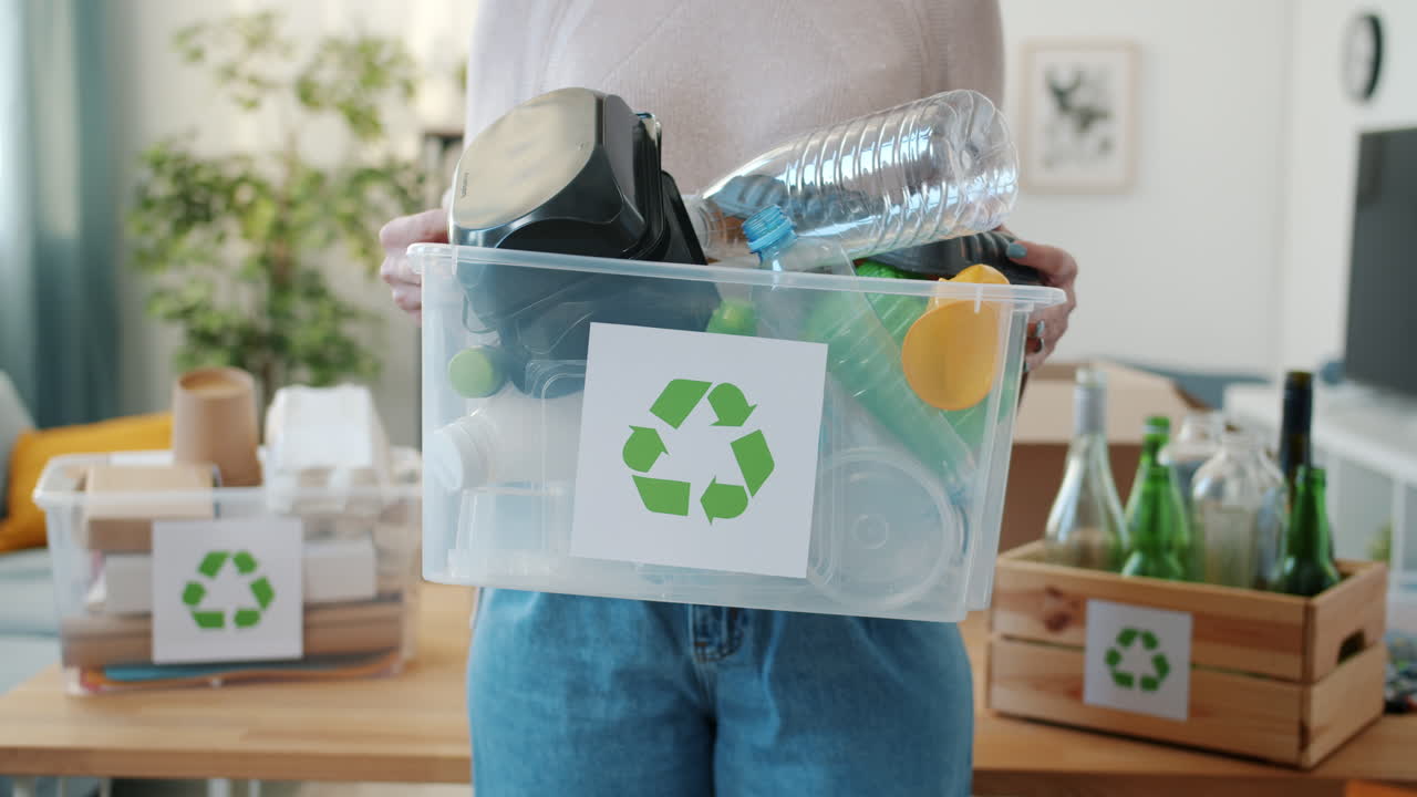 Woman Holding Recycling Bin with Assorted Recyclable Materials