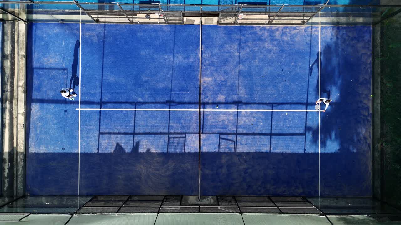 Overhead view of padel players on a blue court