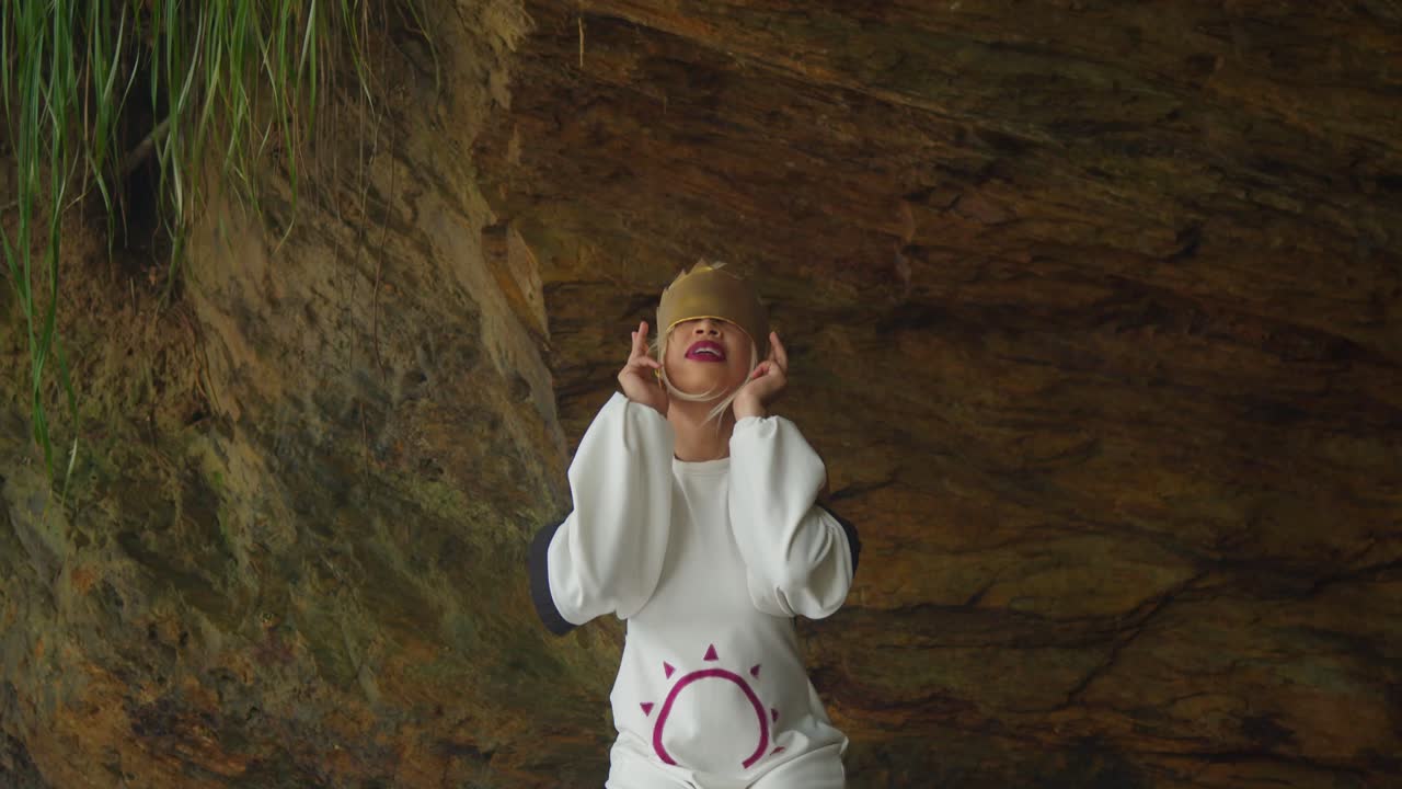 A magical realism shot of a pale elf cosplayer interacting with tropical nature on a secluded Caribbean beach