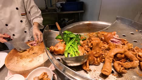 chef prepares traditional stewed pork leg rice