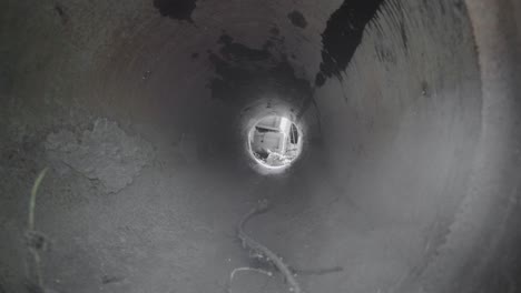 exit from the dry drainage sewage tunnel pipe. concrete drainage pipe, collector of city sewage system. dolly.